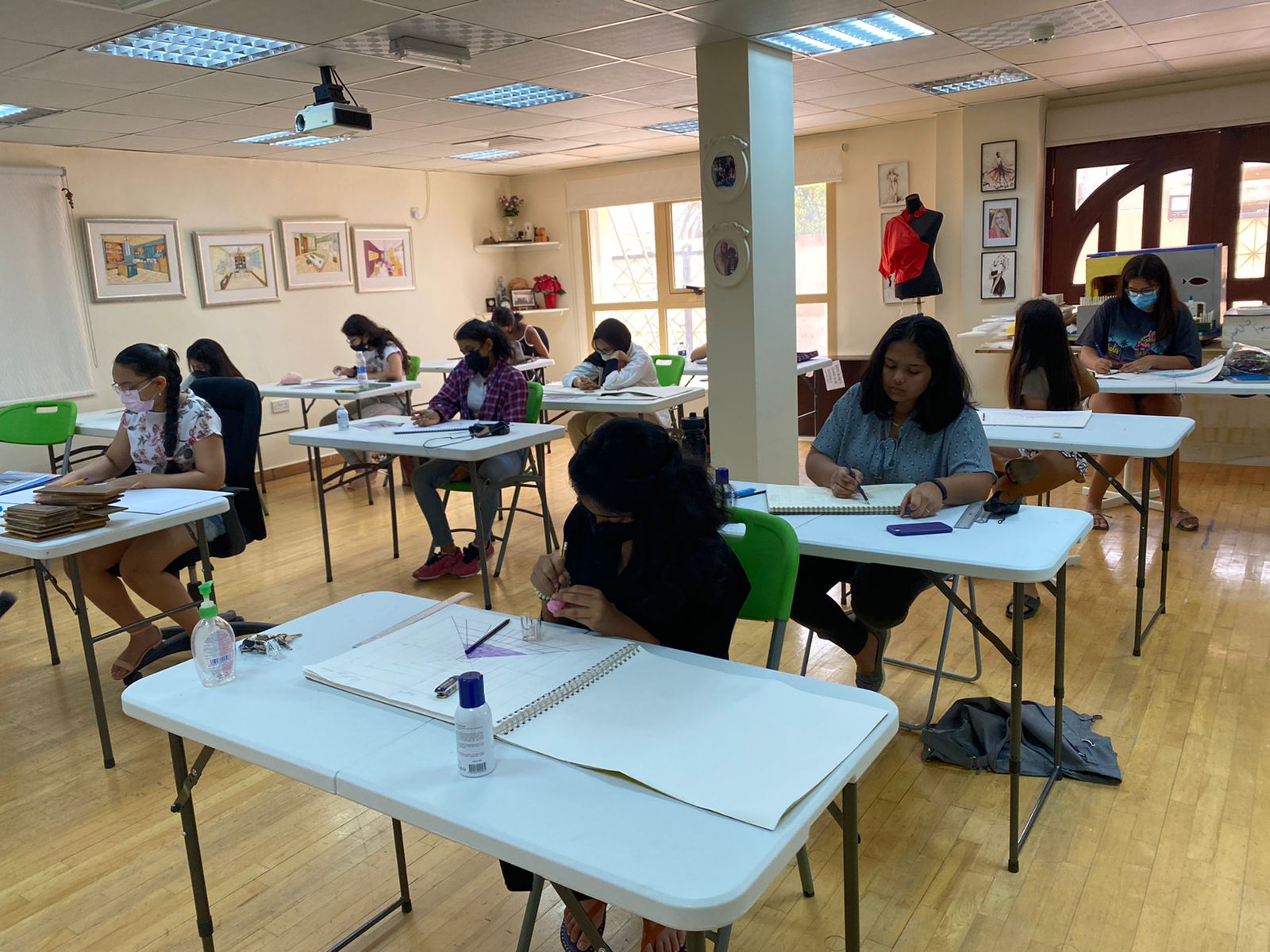 Children seated in art class and working on their desks
