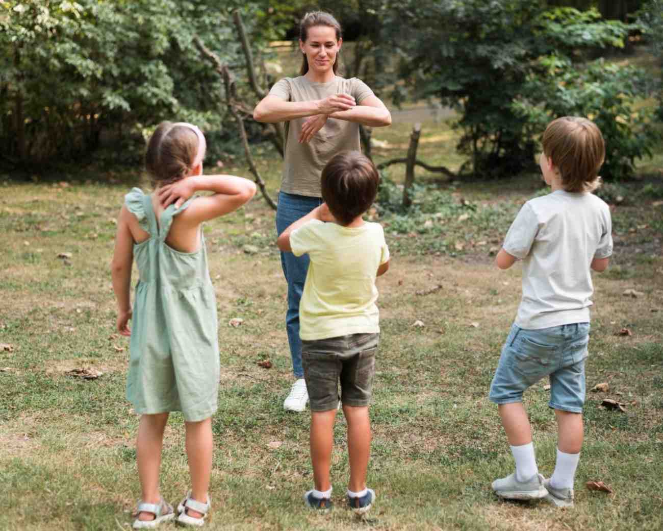 childrens following instructors instructions as they pay attention while they are outside