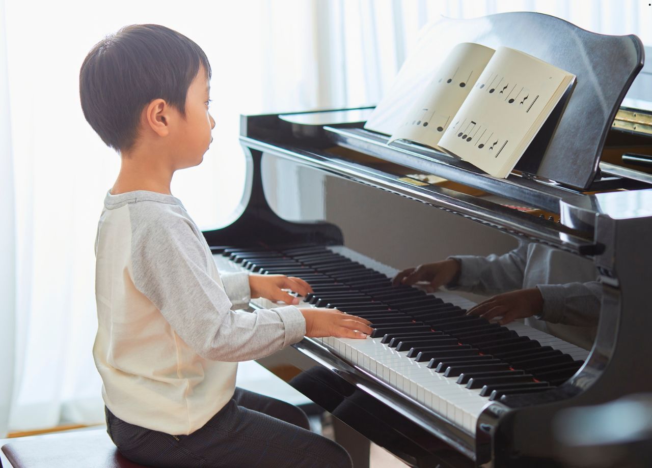 A little boy playing the piano