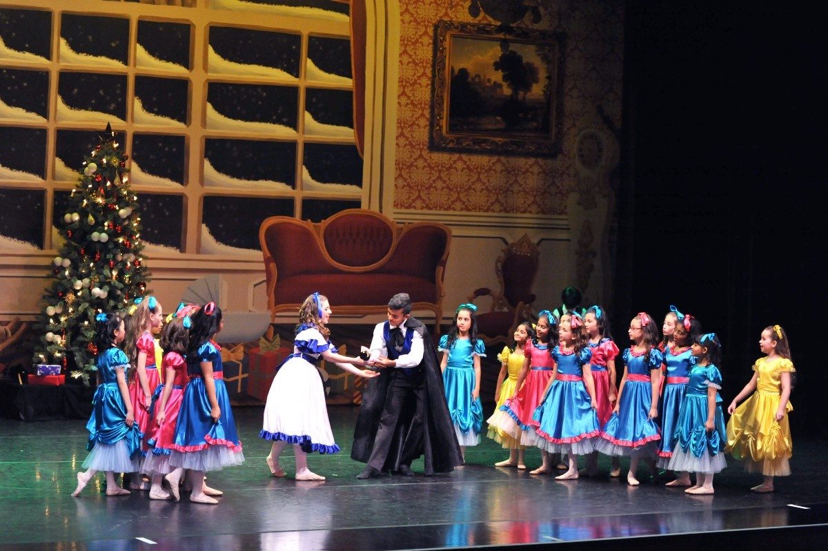 Children on stage acting wearing various costumes