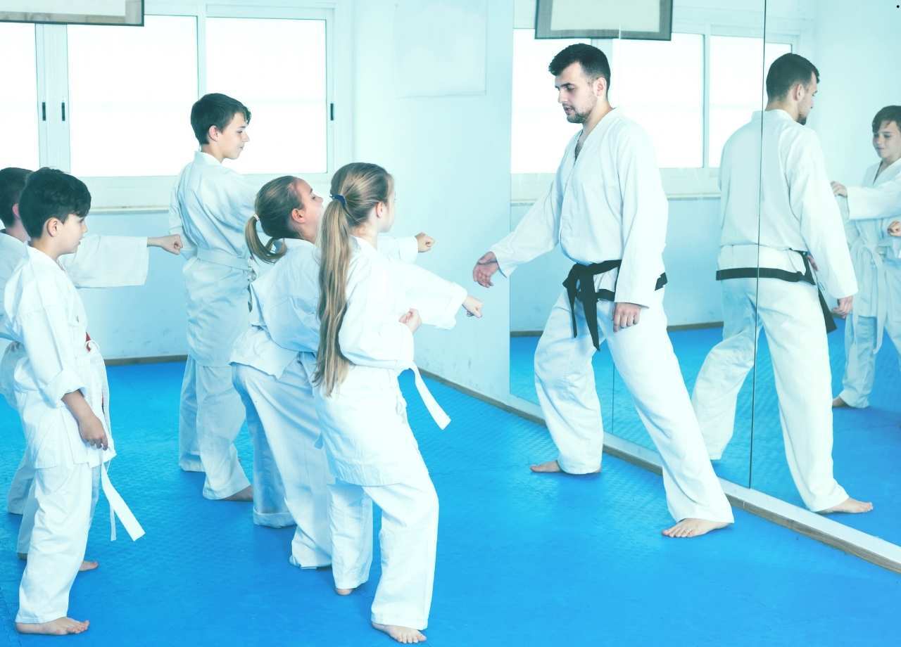 Kids i martial arts class wearing martial arts kit