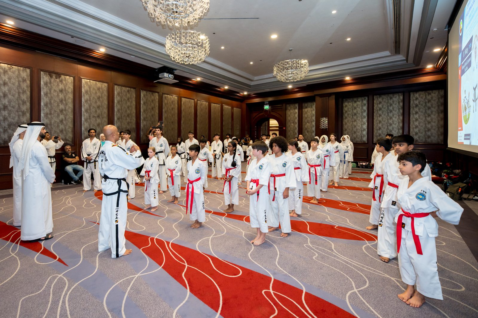 Children in hall with Taekwondo instructor at the front of the class