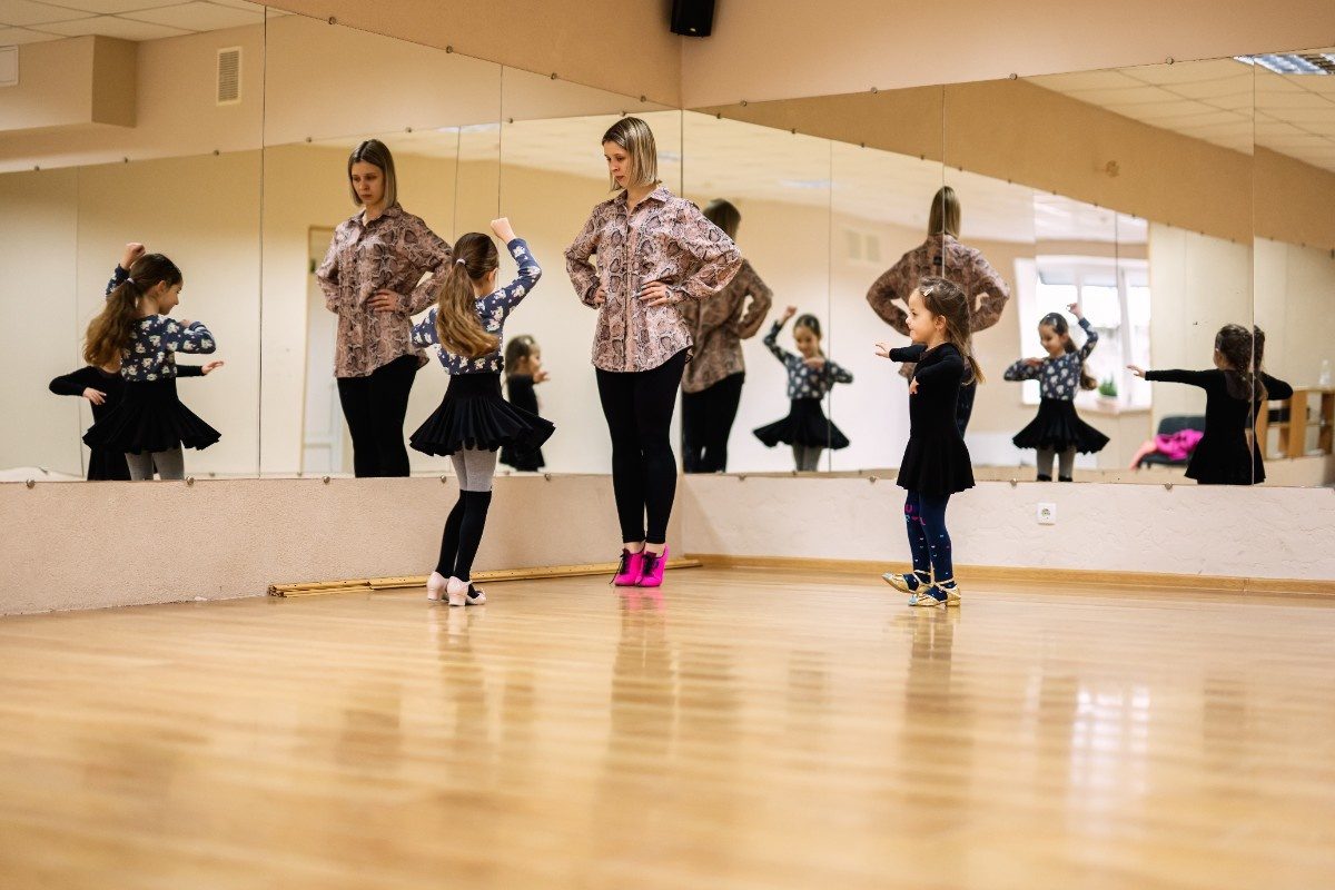 Two little girls in the studio with female dance instructor