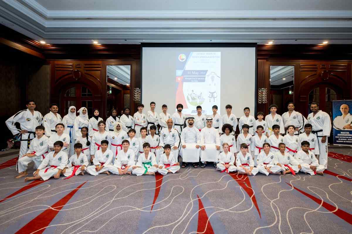 taekwondo group of students sitting and posing for photo