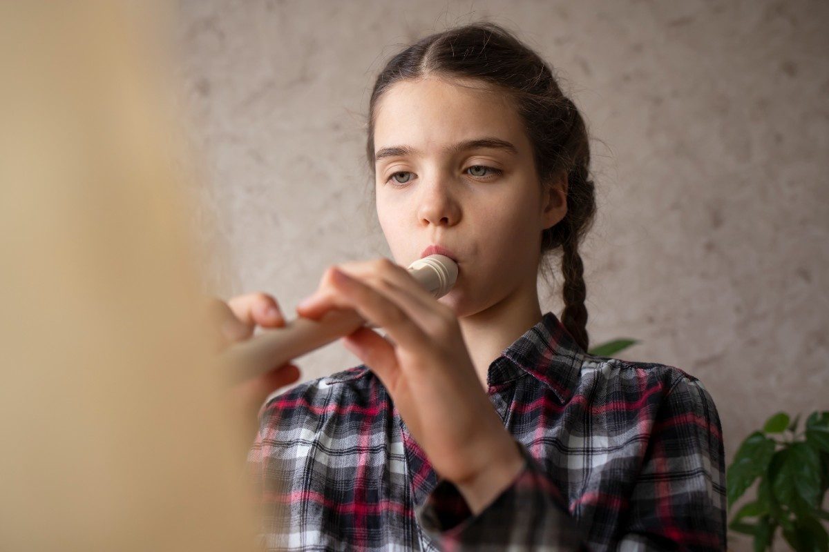A girl child playing a flute