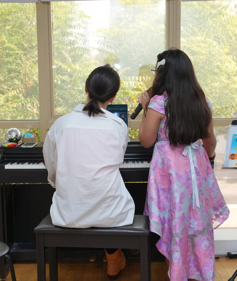 A student playing electric guitar at the centre