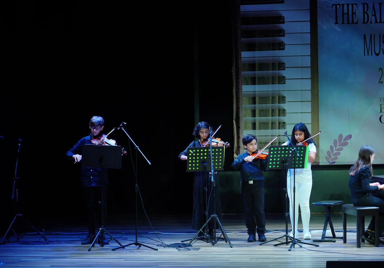 Violin students performing together at the annual music show