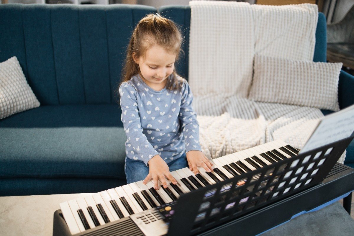 A young student playing an electronic keyboard