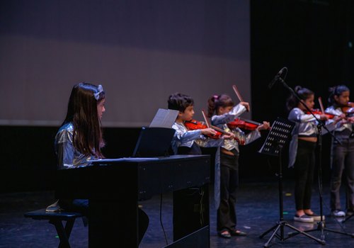 Students playing music together in a class at the centre