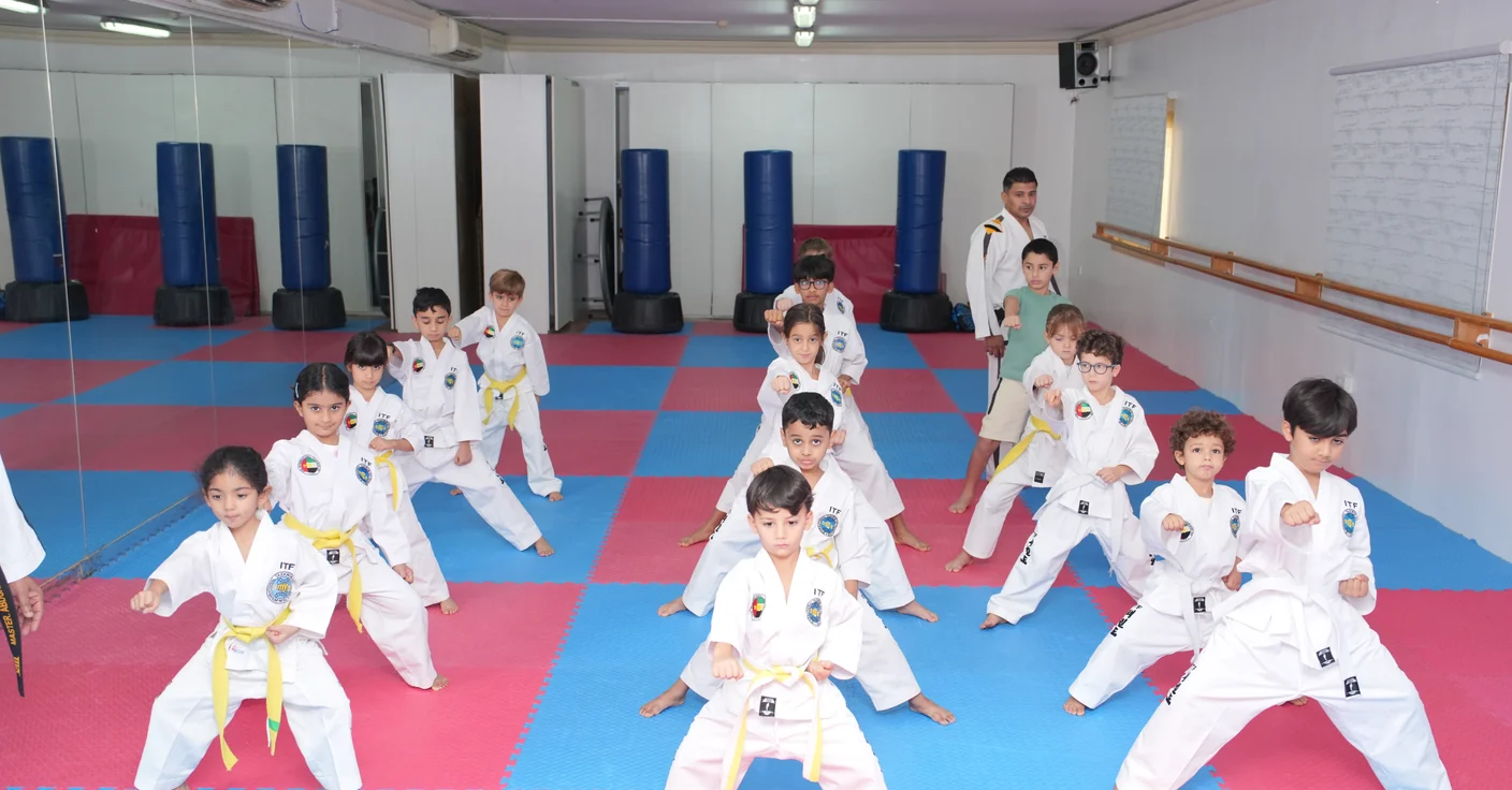 A taekwondo class seated in the training hall at the Jumeirah centre