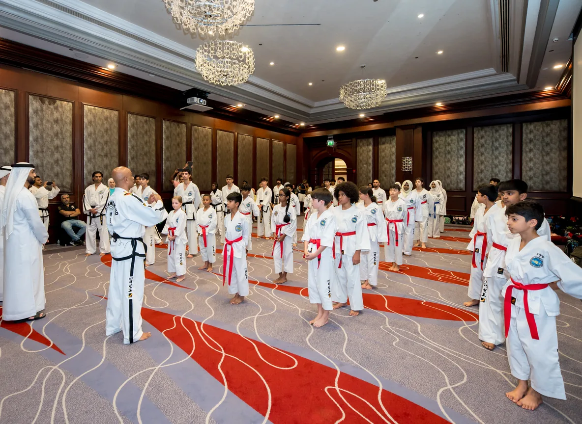 Taekwondo students lined up in formation with their instructor